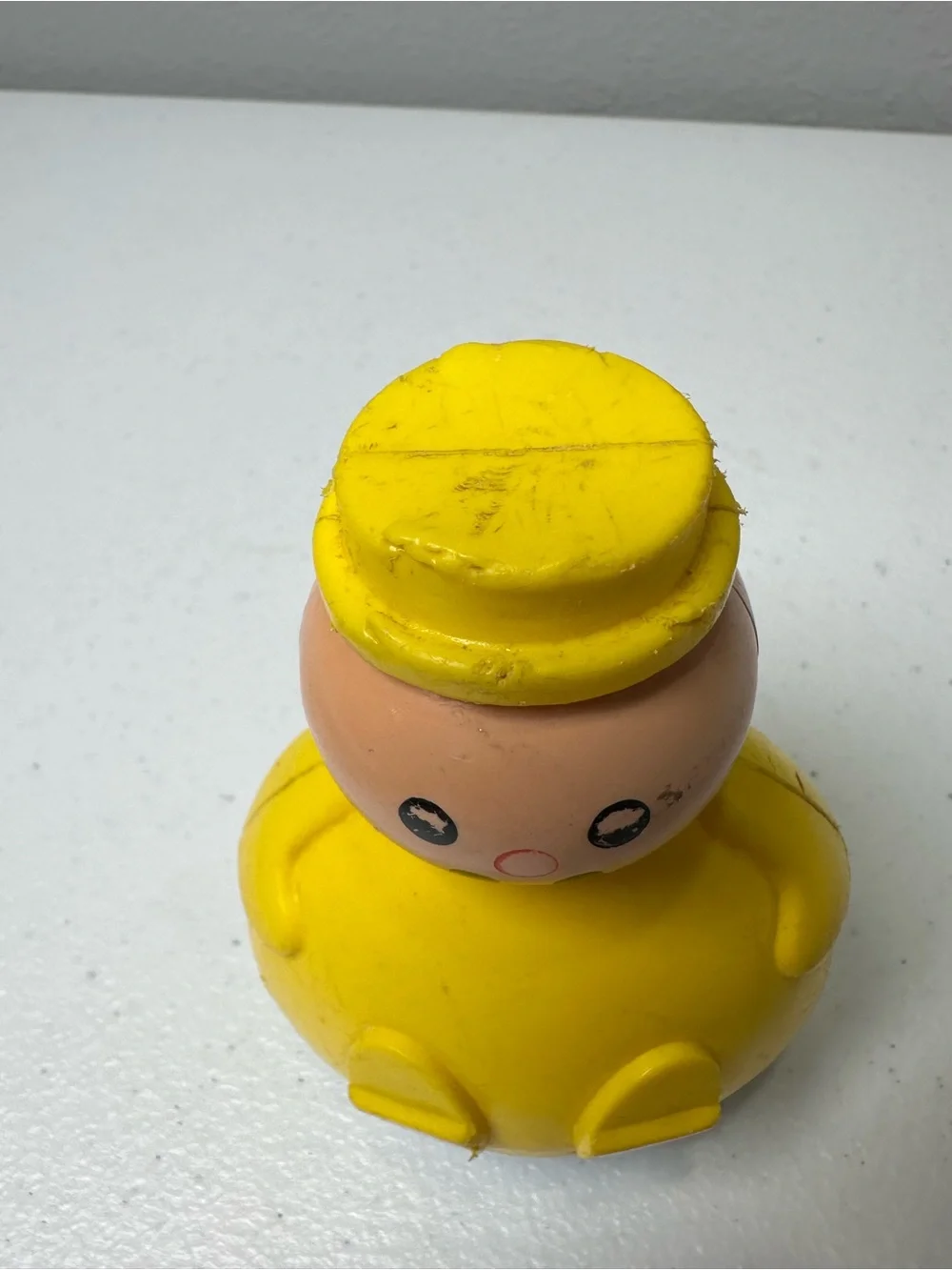 Fisher-Price Yellow Roly-Body Toy with Peach Face and Blue Base